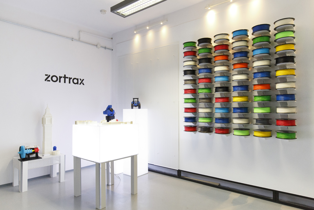 Wall-mounted display of colourful Zortrax filament spools